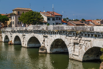 Fototapeta na wymiar RIMINI / ITALY - JULY 2015: View to ancient Roman bridge in the historic centre of Rimini, Italy