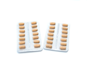 Pills in the blister pack, isolated over white background. Medical treatment and healthcare concept. Selective focus. Copy space