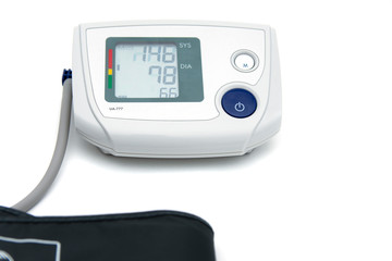 Medical electronic device for measuring blood pressure, isolated on white background. Health care and health heart concept. Blood pressure monitoring. Selective focus. 