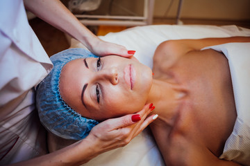 doctor cosmetologist doing facial massage girl Spa