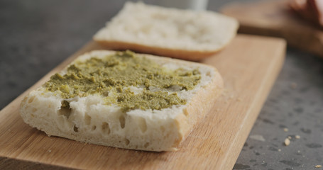 pesto on ciabatta slice on oak board