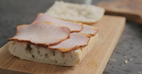 making sandwich with pesto and smoked pork