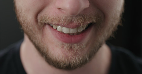 closeup shot of bearded man mouth laughing