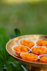 Thai desserts, Tong Yip (Flower Egg Yolk Tart) Egg yolk, sugar, and flower water boiled in sugar syrup and formed into flower like shape