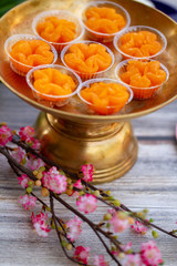 Thai desserts, Tong Yip (Flower Egg Yolk Tart) Egg yolk, sugar, and flower water boiled in sugar syrup and formed into flower like shape