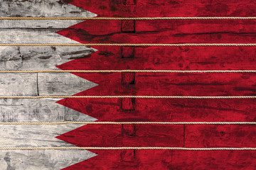 National flag  of Bahrain. on a wooden wall background. The concept of national pride and a symbol...