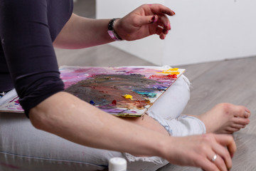 artist painting on canvas