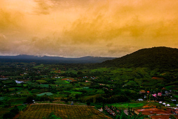 Fototapeta premium The blurred abstract background of a colorful mist fading over the forested mountains, showing the distribution of trees and the integrity of the ecosystem.