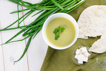 Cream broccoli soup with feta cheese and tortilla in containers on a white background. Takeaway. Diet and healthy food.