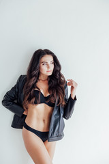 Fototapeta premium brunette girl in leather jacket and black lingerie