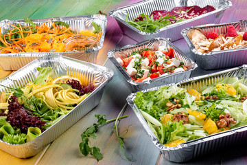 A set of diet dishes in containers on a colored wooden background. Takeaway. Diet and healthy food.