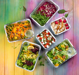 A set of diet dishes in containers on a colored wooden background. Takeaway. Diet and healthy food.