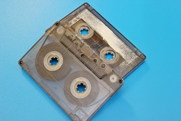 Plastic transparent audio cassettes located on a blue background