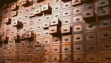 Old wooden textured drawers background in chinese herbal medicine shop in china.Vintage asian...