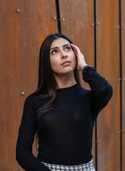 Fototapeta premium Beautiful girl model posing against the background of the modern building