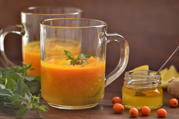 Sea buckthorn tea with lemon, honey and mint