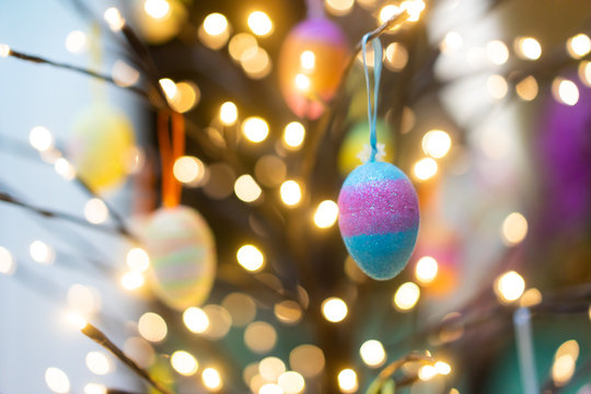 Colorful easter eggs hanging on light tree.Happy easter concept.