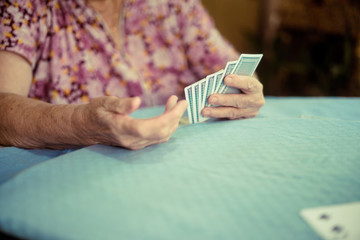 Portrait of seniors elderly old woman playing card game at lunch table at home.brain exercise with card game and alzheimer concept.