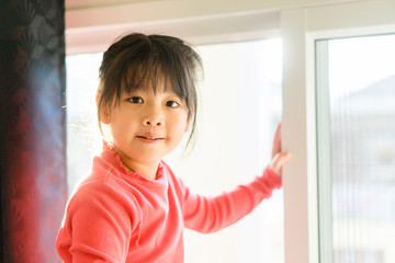 Asian girl with pretty face on window background.