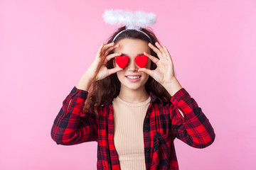 Valentines day. Portrait of happy angelic teen girl with curly brunette hair in plaid shirt and...