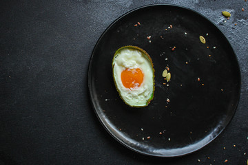 fried eggs in avocado (healthy food, vitamins) menu concept. food background. top view. copy space