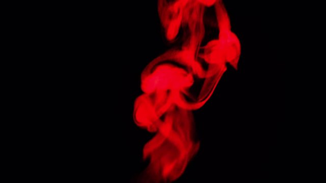 closeup red vapor stream rises from bottom center on black background