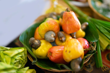 Fresh Cashew nuts on banana leaf.Raw cashews in wooden bowl.
