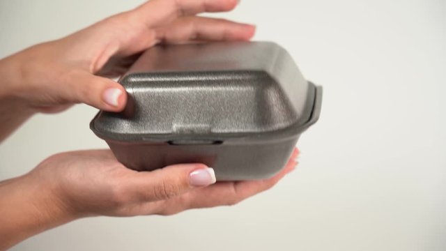 Woman opens box with fresh hot tasty burger laying inside. Real time 4k video footage.