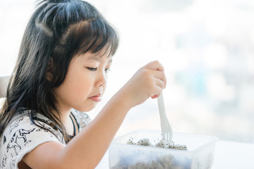 Little asian girl don't want to eat dragon fruit she hate every fruits.bored face bored food.5...
