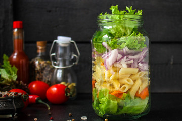 healthy salad in a jar (vegetable snack pasta salad) menu concept. food background. top view. copy space