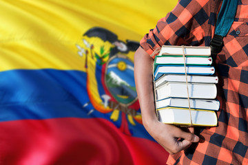 Ecuador national education concept. Close up of teenage student holding books under his arm with...