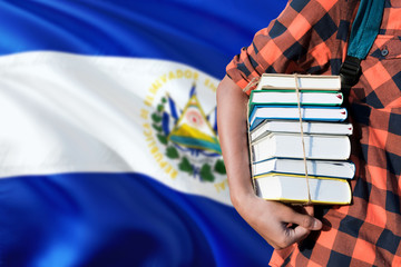 El Salvador national education concept. Close up of teenage student holding books under his arm...
