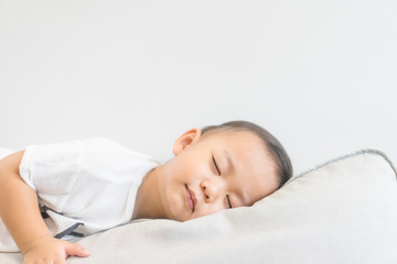 Toddler boy sleeping in sofa and dream.Asian 2 years old baby boy sleep on the sofa in living room.Sleep time,Comfortable, peaceful and growth hormone concept.