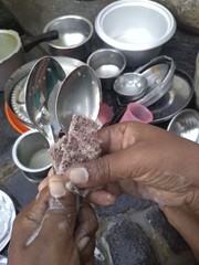 hands of a woman with cleaning the utensils.