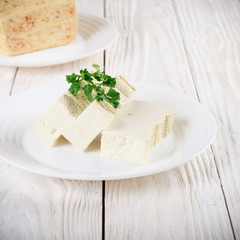 Soy Bean curd tofu on clay dish closeup. Non-dairy alternative substitute for cheese