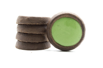 Biscuits crunchy chocolate cookies with green tea flavoured topping choco plus. Isolated on white background.