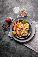 Baked cod steak with vegetables. Healthy and tasty food. Traditional cuisine seafood. Vertical shot