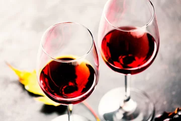 Fotobehang Autumn wine. Red wine in glasses, close-up, clopy space © hannamartysheva