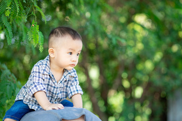Little adorable boy riding piggyback in park
