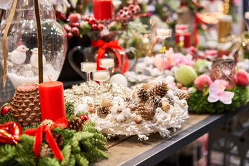 Assortment of European flower shop. Beautiful festive wreath of fresh spruce. Christmas mood. Xmas tree. Bokeh of Garland lights on background