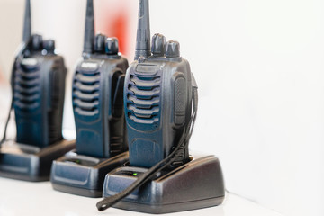 Man's hand holding portable walkie-talkie
