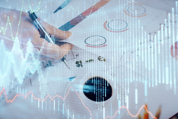 Multi exposure of man planing investment with stock market forex chart.