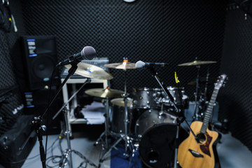 Professional condenser studio microphone, Musical Concept. recording, selective focus microphone in radio studio, selective focus microphone and blur musical equipment guitar,