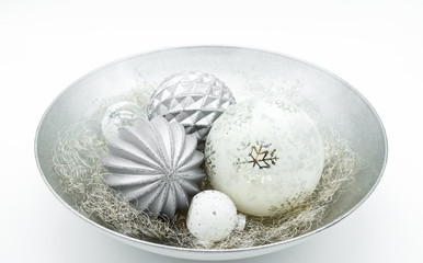bowl of christmas ornaments with christmas balls and angle hair