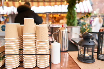 Mulled wine in Christmas market. Paper cups for Christmas mulled wine in old town Small European City.