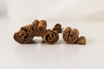 Dry cinnamon sticks closeup on white background, close-up of cinnamon rolls (Cinnamomum verum) - Image