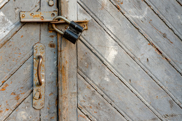texture of an old wooden door. shabby paint. Closed door. Keyhole and door handle close-up. There...