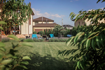 Green garden outside of modern vacation house, creation a home and home feeling