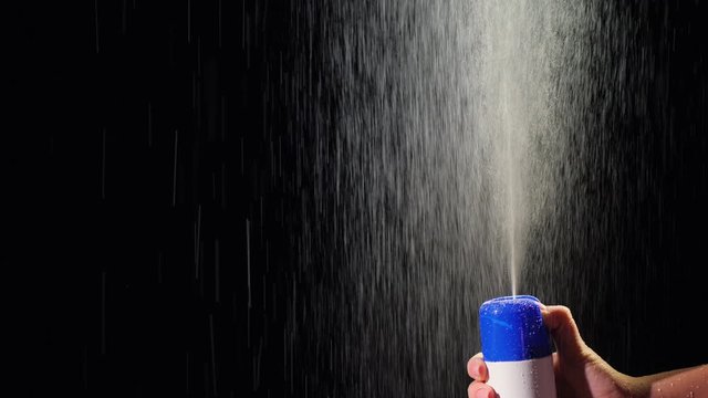 Spray sprayed up on black background