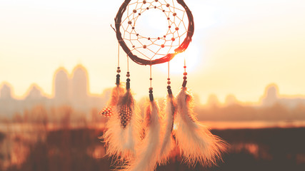 Dream catcher on the background of the big city. Far from the bustle of the city. The concept of conscious life, meditation, self-development, harmony with nature - obrazy, fototapety, plakaty